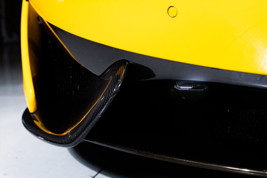 Close-up of the front bumper and carbon fiber detail of a yellow sports car